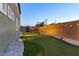 Backyard putting green with decorative gravel, lighting, and block wall, perfect for outdoor games and relaxation at 3386 W Haleh Ave, Las Vegas, NV 89141