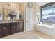 Bathroom features granite double sink vanity, soaking tub, and large window with view at 3386 W Haleh Ave, Las Vegas, NV 89141