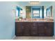 Stylish bathroom features a double vanity, stone countertops, and modern fixtures at 3386 W Haleh Ave, Las Vegas, NV 89141