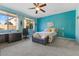 Bright bedroom with large windows, ceiling fan and ensuite workspace at 3386 W Haleh Ave, Las Vegas, NV 89141