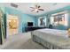Bedroom with large windows, blue walls and connecting hallway at 3386 W Haleh Ave, Las Vegas, NV 89141