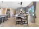Dining room features a long wooden table, tiled flooring, and lots of natural light at 3386 W Haleh Ave, Las Vegas, NV 89141