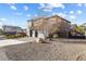 Spacious two-story home with a three-car garage, rock landscaping and a desert-style yard at 3386 W Haleh Ave, Las Vegas, NV 89141