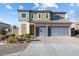 Two-story home showcasing stone accents and a three-car garage, complemented by neat landscaping at 3386 W Haleh Ave, Las Vegas, NV 89141