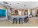 Open-concept kitchen featuring dark wood cabinets, granite countertops, and a breakfast bar at 3386 W Haleh Ave, Las Vegas, NV 89141