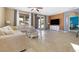 Inviting living room boasts tile flooring, a comfortable sectional, and sliding doors to the backyard at 3386 W Haleh Ave, Las Vegas, NV 89141