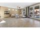 Relaxing living room boasts tile flooring, a comfortable sectional, and sliding doors to the backyard at 3386 W Haleh Ave, Las Vegas, NV 89141