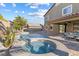 Backyard featuring a pool, spa, covered patio, and outdoor kitchen space, perfect for entertainment at 3386 W Haleh Ave, Las Vegas, NV 89141