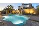 Inviting backyard pool and spa featuring multiple waterfalls, mature landscaping, and stone retaining wall at 3386 W Haleh Ave, Las Vegas, NV 89141