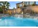 Beautiful pool with water feature, statue, rock detail, and adjacent patio area at 3386 W Haleh Ave, Las Vegas, NV 89141