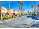 Gated community with palm trees, landscaping, and multiple units at 3660 Renovah St # 204, Las Vegas, NV 89129