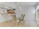 Cozy dining area features tile floors, a chandelier, and a view into the adjacent kitchen at 3660 Renovah St # 204, Las Vegas, NV 89129