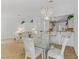 Open floor plan featuring dining area with glass table, adjacent to the kitchen and living room at 3660 Renovah St # 204, Las Vegas, NV 89129