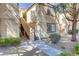 Condo exterior showcasing the well-maintained stucco facade and desert-friendly landscaping at 3660 Renovah St # 204, Las Vegas, NV 89129