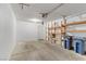 Attached garage with shelving and two blue trash receptacles at 3660 Renovah St # 204, Las Vegas, NV 89129