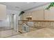 Well-lit kitchen features granite countertops, tiled backsplash, and modern appliances at 3660 Renovah St # 204, Las Vegas, NV 89129