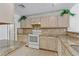 Bright kitchen featuring granite countertops and white appliances at 3660 Renovah St # 204, Las Vegas, NV 89129