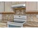 Close up of the white smooth top range and stainless steel hood fan at 3660 Renovah St # 204, Las Vegas, NV 89129