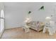 Bright living room with neutral color palette, tile floors, sofa, and stylish glass top tables at 3660 Renovah St # 204, Las Vegas, NV 89129