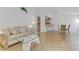 Bright living room features modern glass table, open layout to kitchen and dining area at 3660 Renovah St # 204, Las Vegas, NV 89129