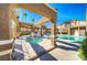 Community pool and spa with shade structures at 3660 Renovah St # 204, Las Vegas, NV 89129