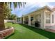 Beautiful backyard with lush lawn, covered patio, and space for outdoor entertaining at 3684 Miguels Ln, Las Vegas, NV 89120