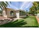Charming home with an outdoor oasis, featuring a well-maintained lawn, and a covered patio at 3684 Miguels Ln, Las Vegas, NV 89120