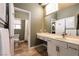Bright bathroom features tile floors, large mirror, and vanity with sink and storage at 3684 Miguels Ln, Las Vegas, NV 89120