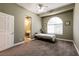 Bedroom features a large arched window, neutral walls, carpet, and bathroom view at 3684 Miguels Ln, Las Vegas, NV 89120