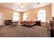 Spacious bedroom with large windows, carpeted floors, and a ceiling fan at 3684 Miguels Ln, Las Vegas, NV 89120