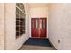Welcoming entryway with striking red double doors and a side window providing natural light at 3684 Miguels Ln, Las Vegas, NV 89120