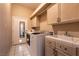 Laundry room featuring washer, dryer, and sink with cabinet space at 3684 Miguels Ln, Las Vegas, NV 89120