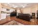 Open-concept living room and kitchen area with a fireplace and hardwood floors at 3684 Miguels Ln, Las Vegas, NV 89120