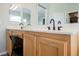 Bathroom with dual vanity sink, wooden cabinets, and large mirror at 3721 Moonshine Falls Ave, North Las Vegas, NV 89085