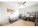 Bedroom with a ceiling fan, gray couch, artwork and dual workstations at 3721 Moonshine Falls Ave, North Las Vegas, NV 89085