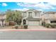 Charming two-story home with a well-manicured lawn, a driveway, and attached two-car garage at 3721 Moonshine Falls Ave, North Las Vegas, NV 89085