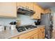 Functional kitchen design featuring stainless steel appliances, a gas cooktop, and light wood cabinetry at 3721 Moonshine Falls Ave, North Las Vegas, NV 89085