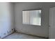 View of a bedroom with stained walls, one window, and a door at 3761 Tohono Canyon St, Las Vegas, NV 89147