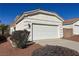 A well-maintained home garage with an easy access driveway and manicured landscaping at 3761 Tohono Canyon St, Las Vegas, NV 89147