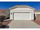 Exterior shot of the home's garage with a large driveway and well-maintained landscaping at 3761 Tohono Canyon St, Las Vegas, NV 89147