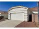 Home's garage with a white door, easy driveway access, and a terra cotta roof at 3761 Tohono Canyon St, Las Vegas, NV 89147