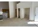 Spacious living room with high ceilings, open to the kitchen, and doorway access to other rooms at 3761 Tohono Canyon St, Las Vegas, NV 89147