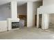 Open-concept living room featuring a fireplace, high ceilings, and seamless flow to the kitchen space at 3761 Tohono Canyon St, Las Vegas, NV 89147