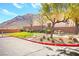 Community area featuring a picnic table, grass, trees, and a mountain backdrop at 3920 Beverly Elms St, Las Vegas, NV 89129