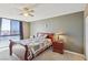 This comfortable bedroom features a ceiling fan and a big window for natural light at 3930 University Center Dr # 804, Las Vegas, NV 89119