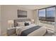 Bright bedroom featuring a large window with city views and comfortable contemporary furnishings at 3930 University Center Dr # 804, Las Vegas, NV 89119