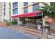 The entrance features a red awning and lush foliage at 3930 University Center Dr # 804, Las Vegas, NV 89119