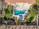 Aerial view of backyard oasis featuring a pool, spa, patio and lush landscaping at 4024 Mansion Hall Ct, Las Vegas, NV 89129