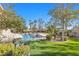 Lush backyard featuring a sparkling pool, spa, and manicured landscaping for relaxation at 4024 Mansion Hall Ct, Las Vegas, NV 89129