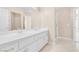 Bathroom with dual sinks, white cabinets, and neutral flooring at 4024 Mansion Hall Ct, Las Vegas, NV 89129